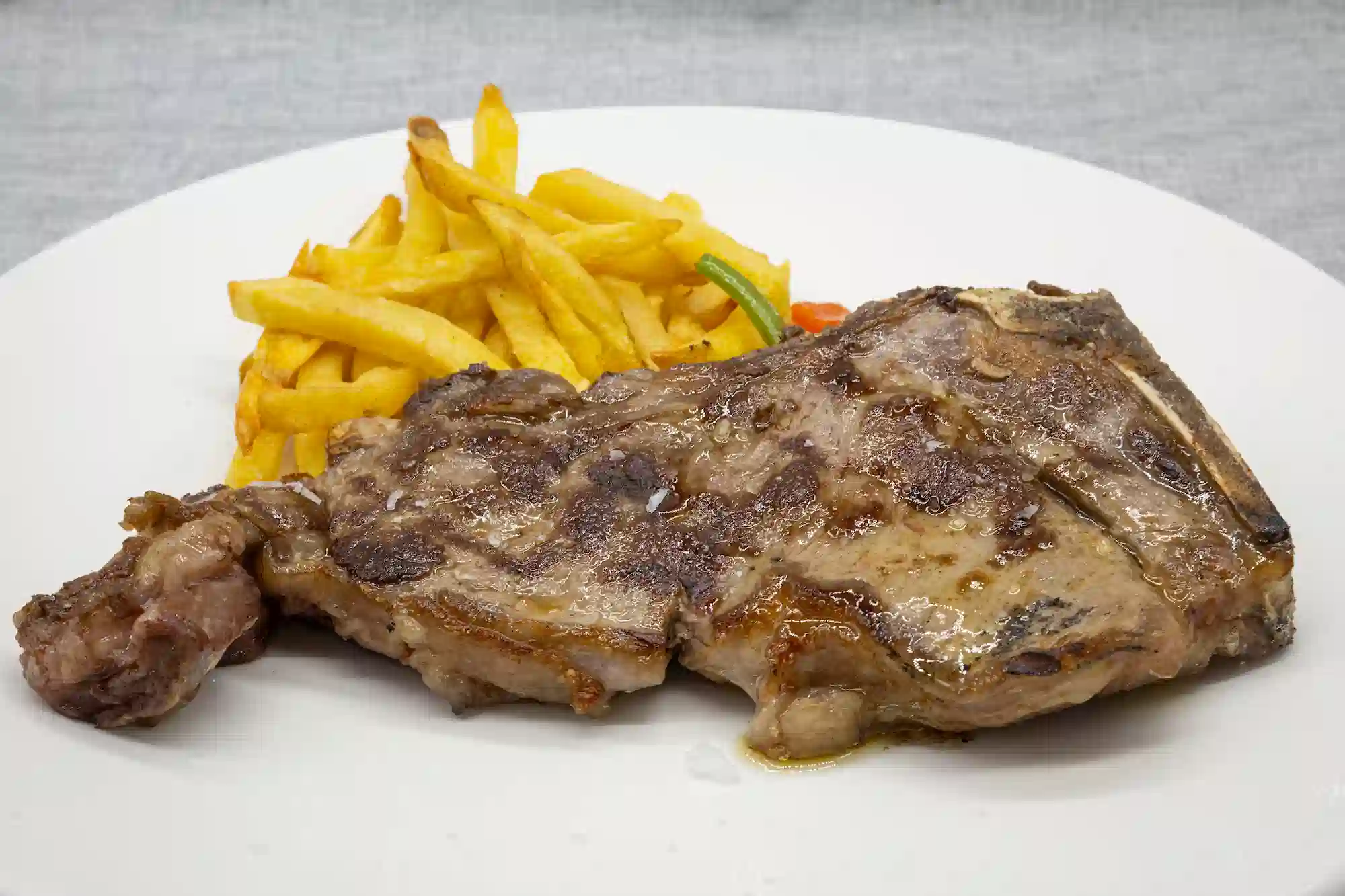 Chuletón de ternera madurado a la brasa (700–800 g) con su guarnición