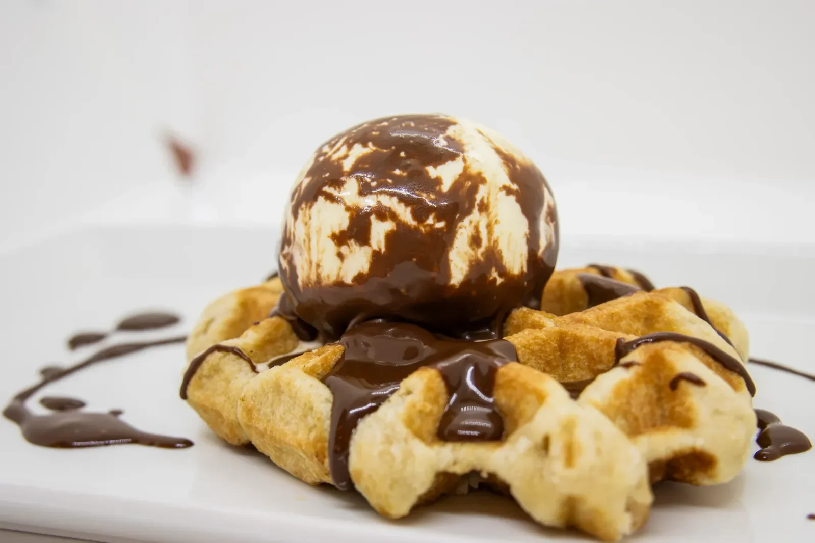 Delicioso gofre con helado y salsa de chocolate en Agumas, restaurante de cocina casera y mediterránea en Albanyà, Girona.
