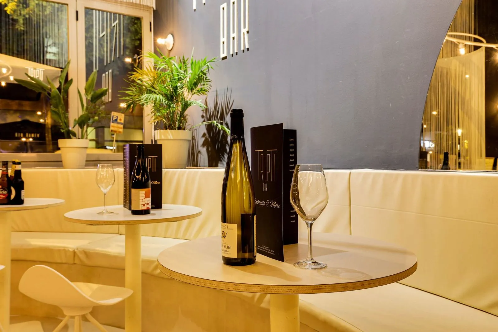 Interior sofisticado del Tripti Bar en Barcelona, con mesas elegantes y ambiente relajado, ideal para disfrutar de coctelería de autor y tapas indias.