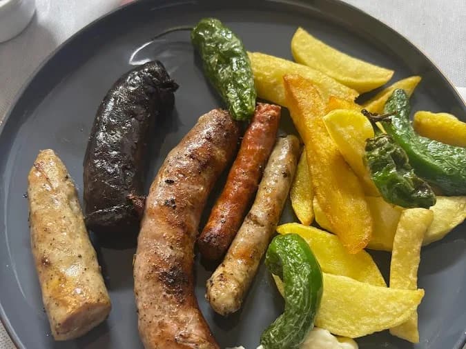 la brasa bandeja de embutidos y pimientos con guarnicion menu maenresa.webp - seleccion de embutidos con pimientos y patatas menu mediodia en la brasa de maenres