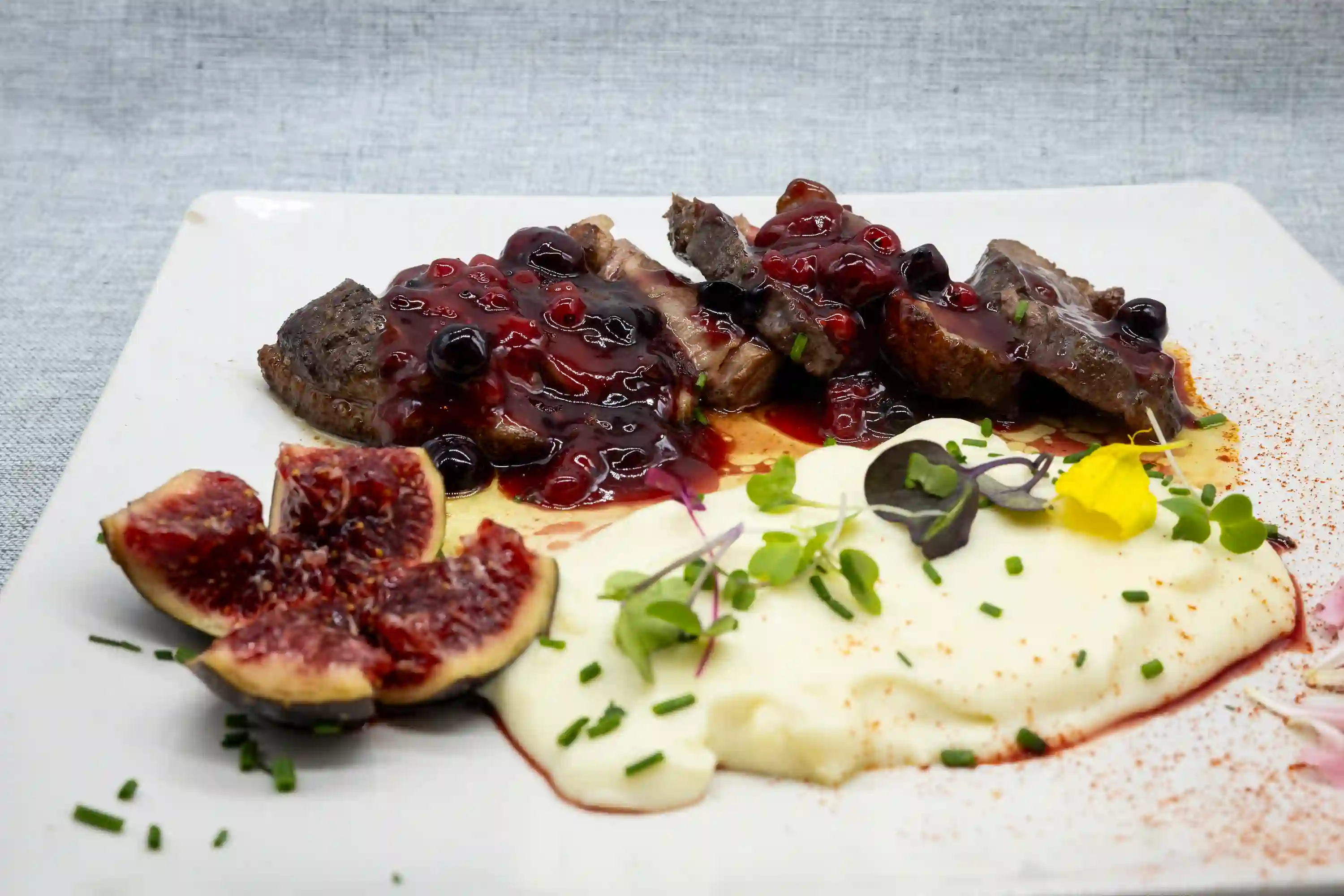 con salsa de frutos rojos pure de patata y higos frescos